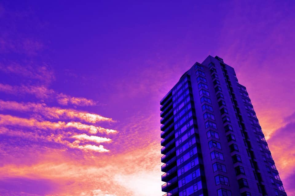 fire safety in high-rise flats with flammable cladding - tower block at sunset