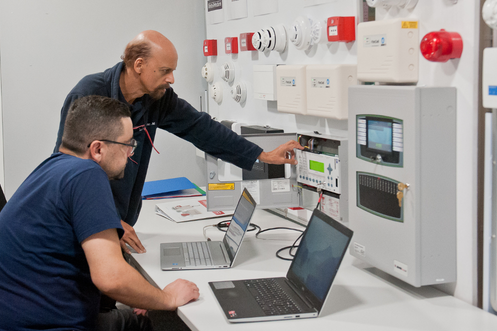Surrey Fire fire alarm testers looking at fire alarms
